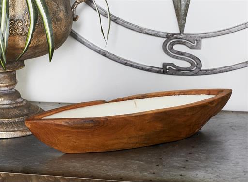 Brown boat-shaped candle holder that is handmade, and comes with a white wax candle inside