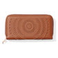 Zippered wallet with circular studs and cutouts on a tan background