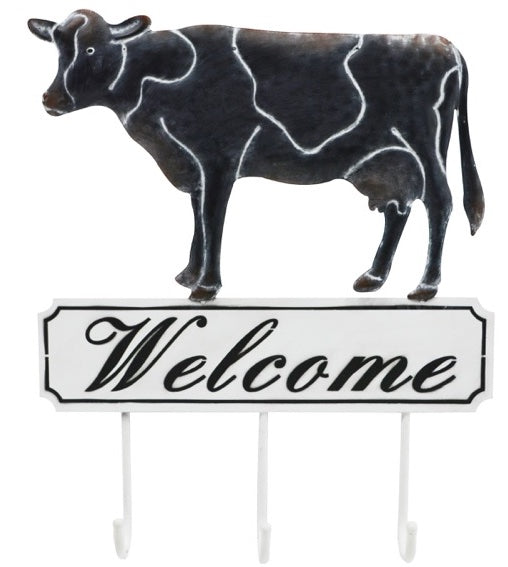 Welcome sign with three hooks in black and white with cow on top of sign
