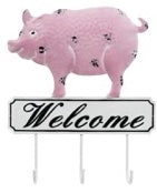 Pig atop a black and white metal welcome sign with three hooks