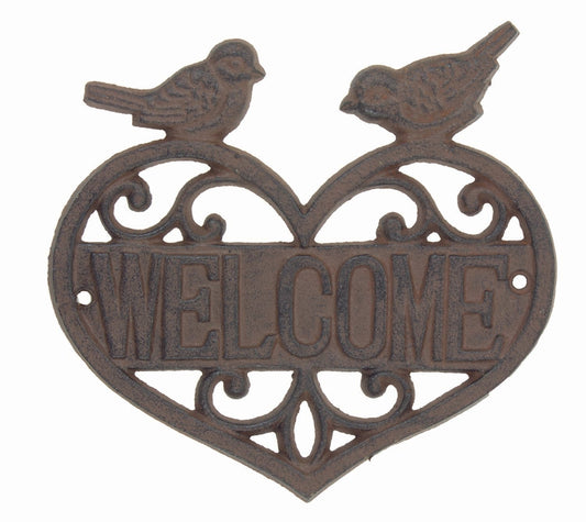 Cast iron bird welcome sign with a filigree design in the shape of a heart and two playful birds perched on top