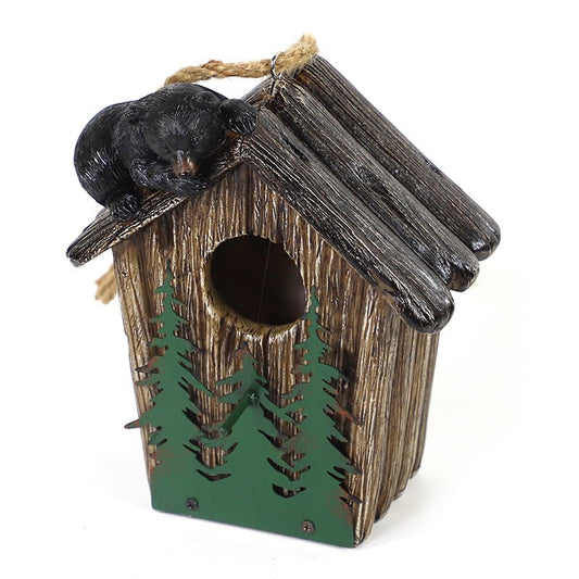 Birdhouse with trees and a bear climbing on the roof. Rope to hang.