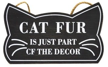 "Cat Fur Is Just Part of the Decor" decorative sign in the shape of a cat headwith a black background and white writing