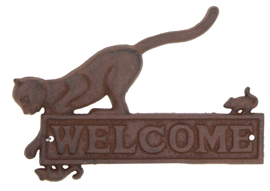 Cat reaching for mouse on cast iron welcome sign